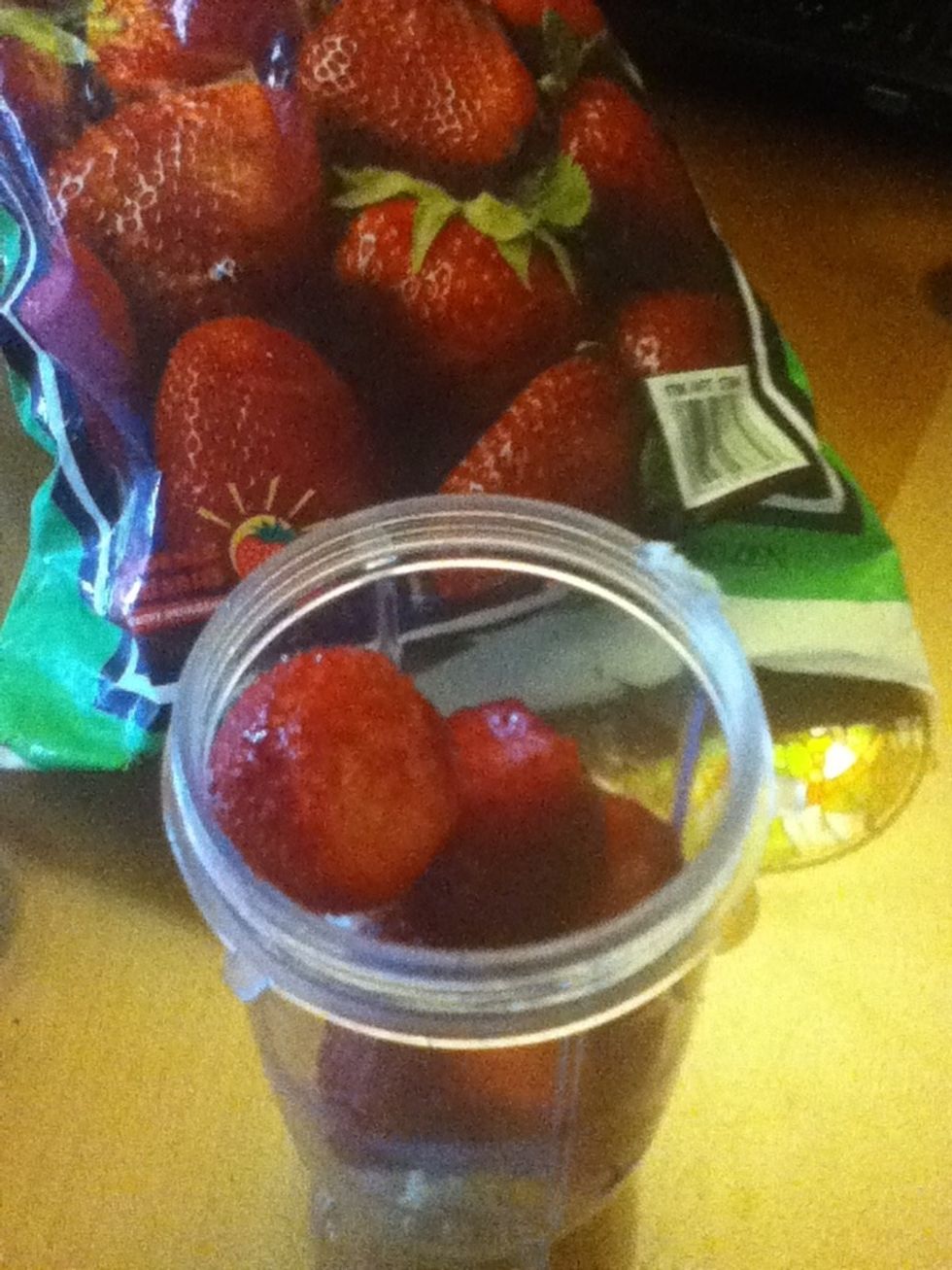 Add 5 frozen strawberries.