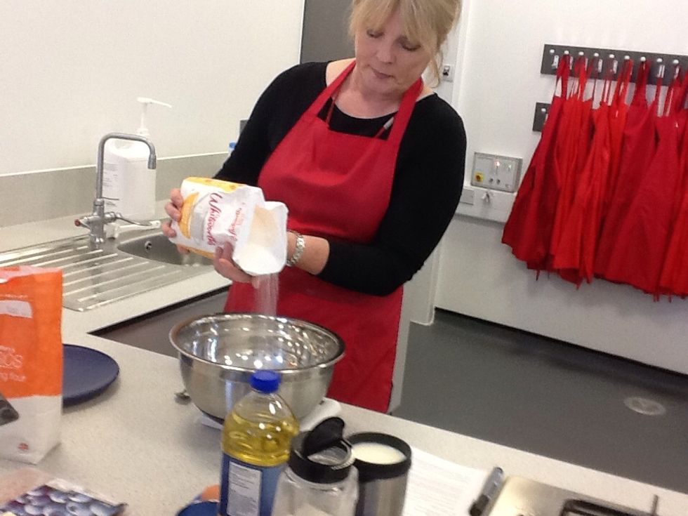 Add 85 grams of caster sugar and a teaspoon of baking powder