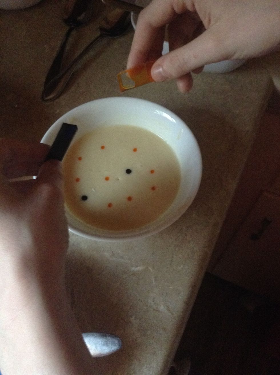 Add 9 drops yellow and 2 drops blue to create green in a separate bowl then stir