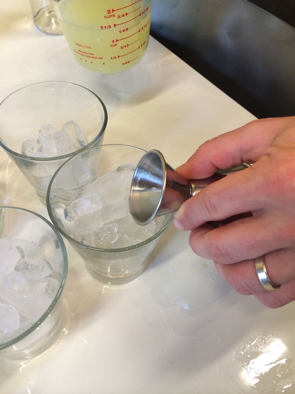 Add a 1/2 ounce of lime juice to each cup.