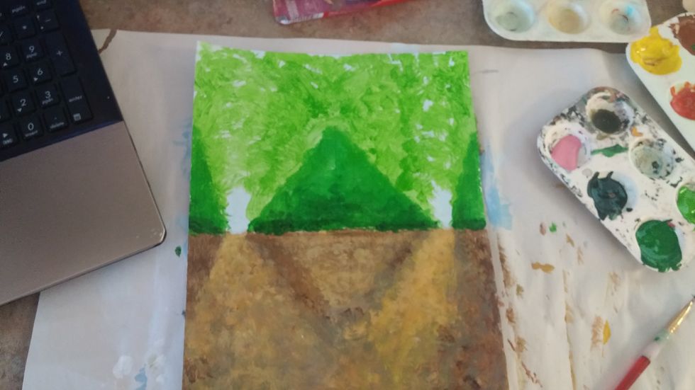 Add a base green to both the top half of the diamonds and then bring that up into the sky, filling most of the area. We are deep in the woods in this picture.