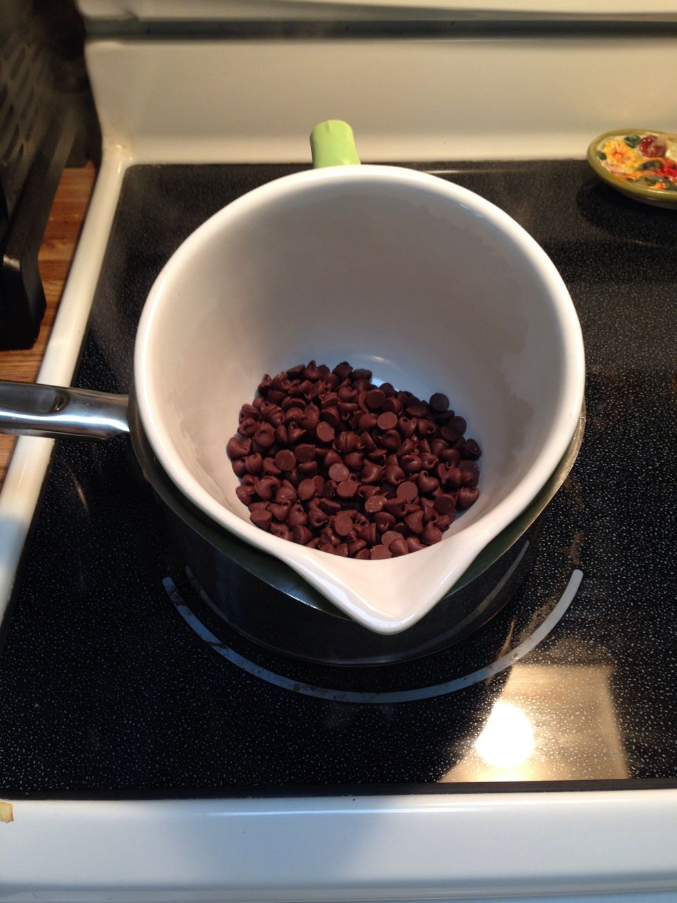 Add a bigger bowl on top of the simmering water pan and add a cup of chocolate chips.