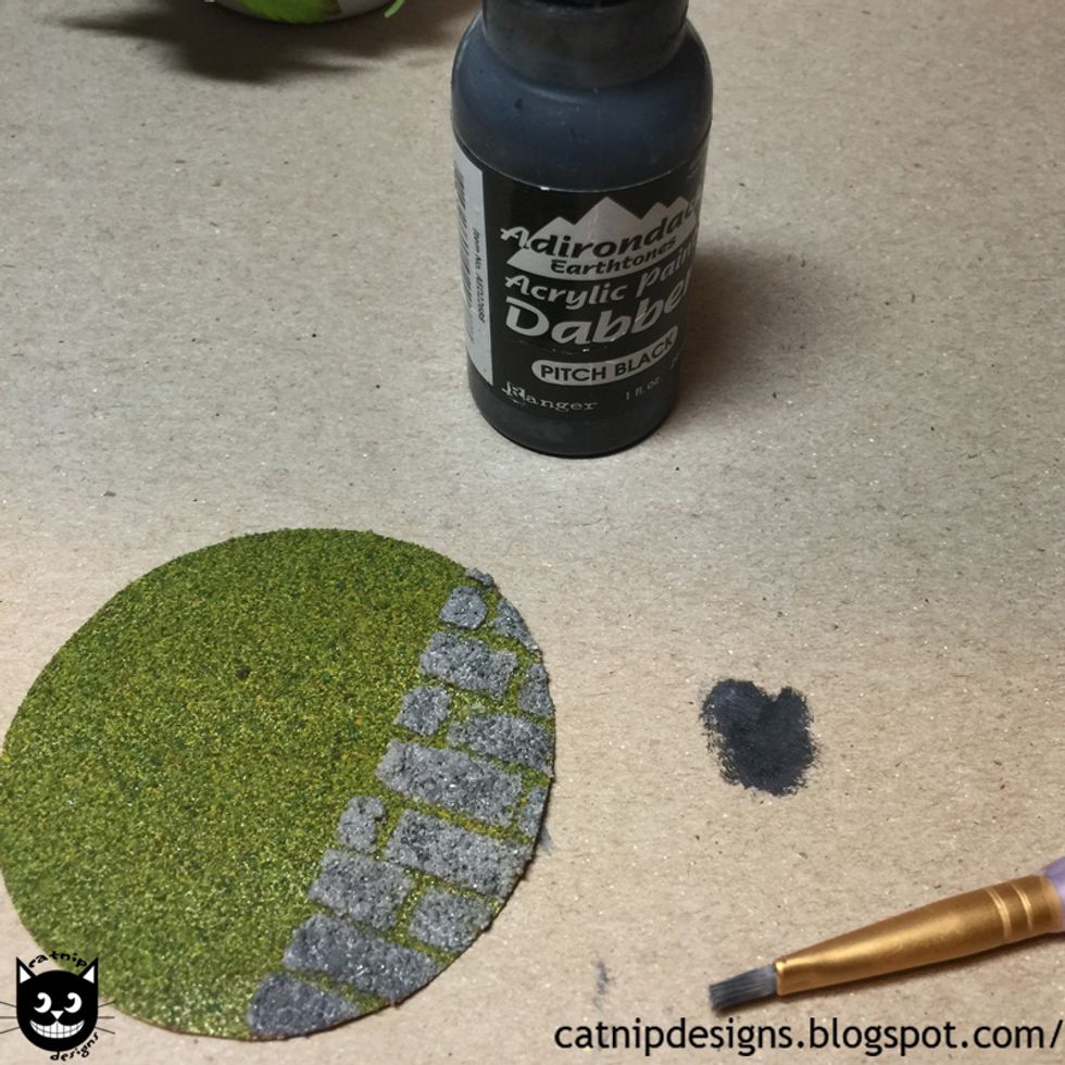 Add a bit of black acrylic paint randomly as shown. This will add dimension to the bricks.