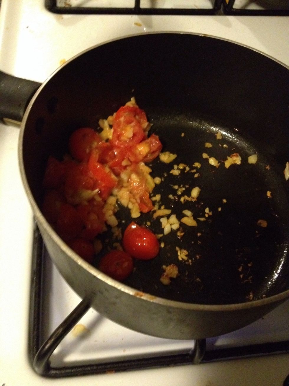 Add a bit of oil, fried garlic, ginger and tomatoes. Gently press down on the tomatoes until it slightly mashes.