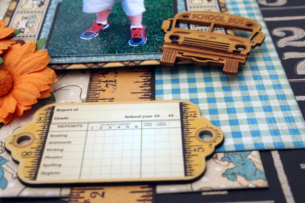 Add a chipboard piece over the ruler near the bottom.  I've also added a wood veneer schoolbus from Creative Embellishments at the corner of the photo.  You could add any embellishment you have.