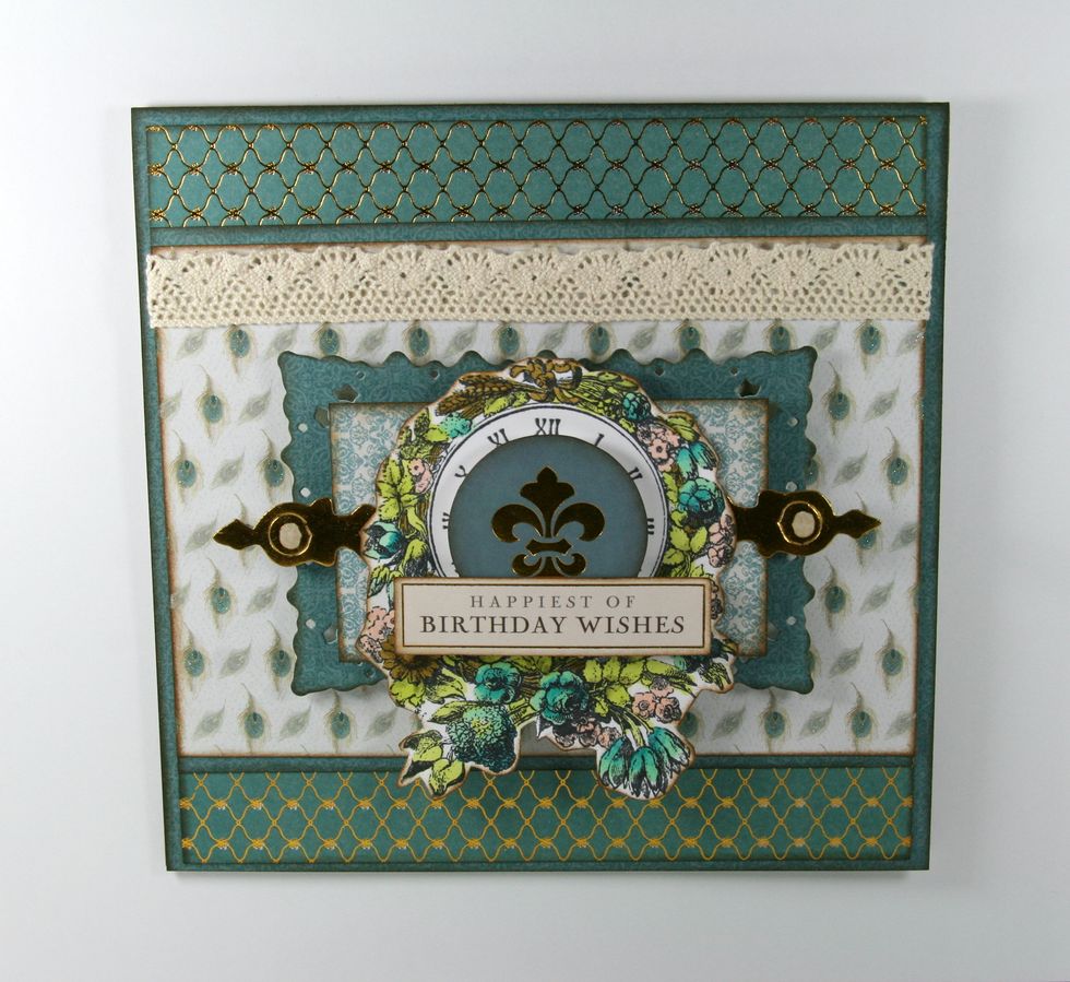 Add a circular foiled element and Birthday Sentiment from the Downton Abbey Card Kit.