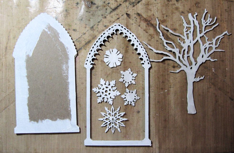 Add a coat of white gesso to all the chipboard pieces.  Paint only the edges of the back of the reliquary frame.  Be sure to paint the sides.