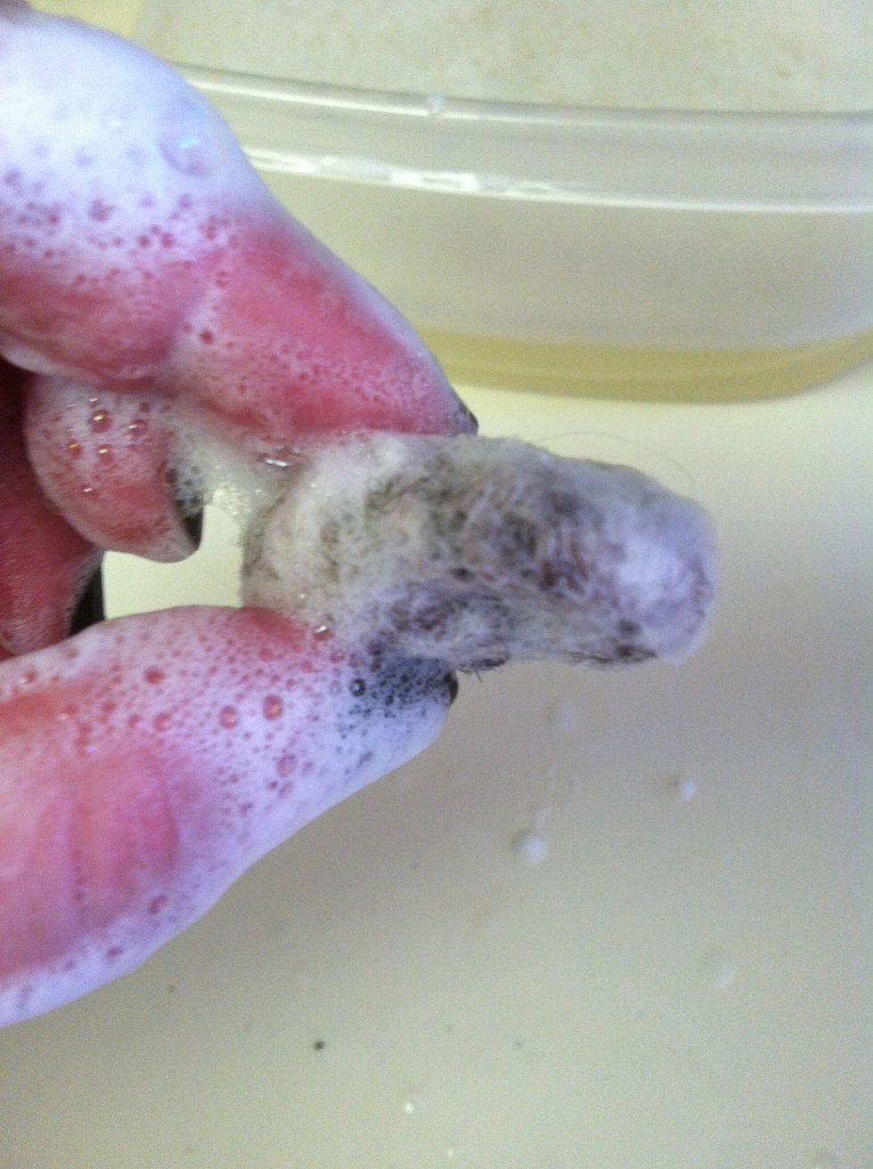 Add a couple of drops of soap to the roving and roll it into a ball between your palms.