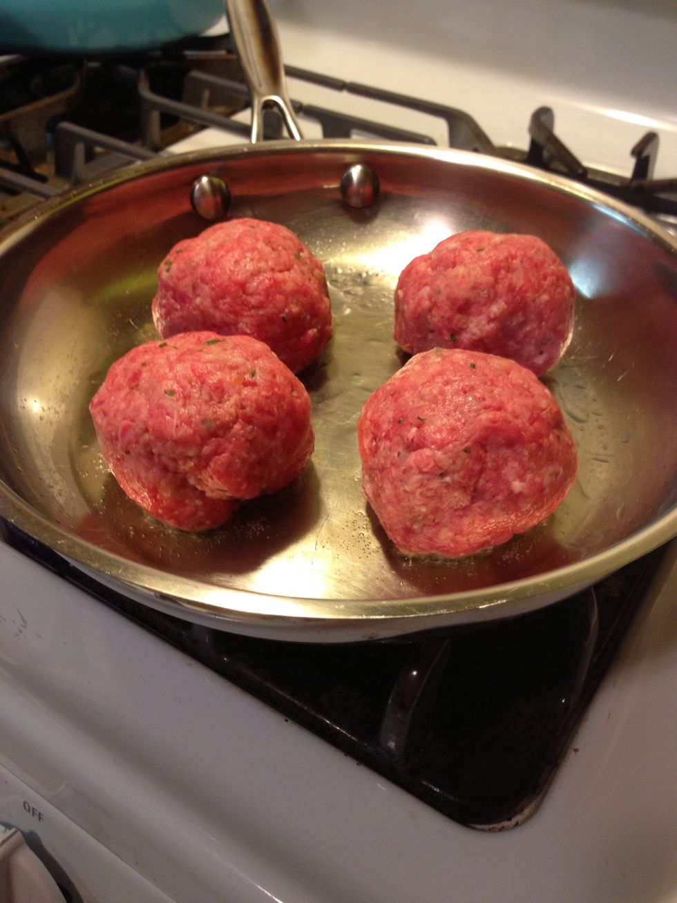 Add a couple tbsp of oil to a medium-hot pan, & add your meatballs. You need to sear them all the way around, so plan on each batch taking about 12 min. Don't crowd the meatballs during this step.