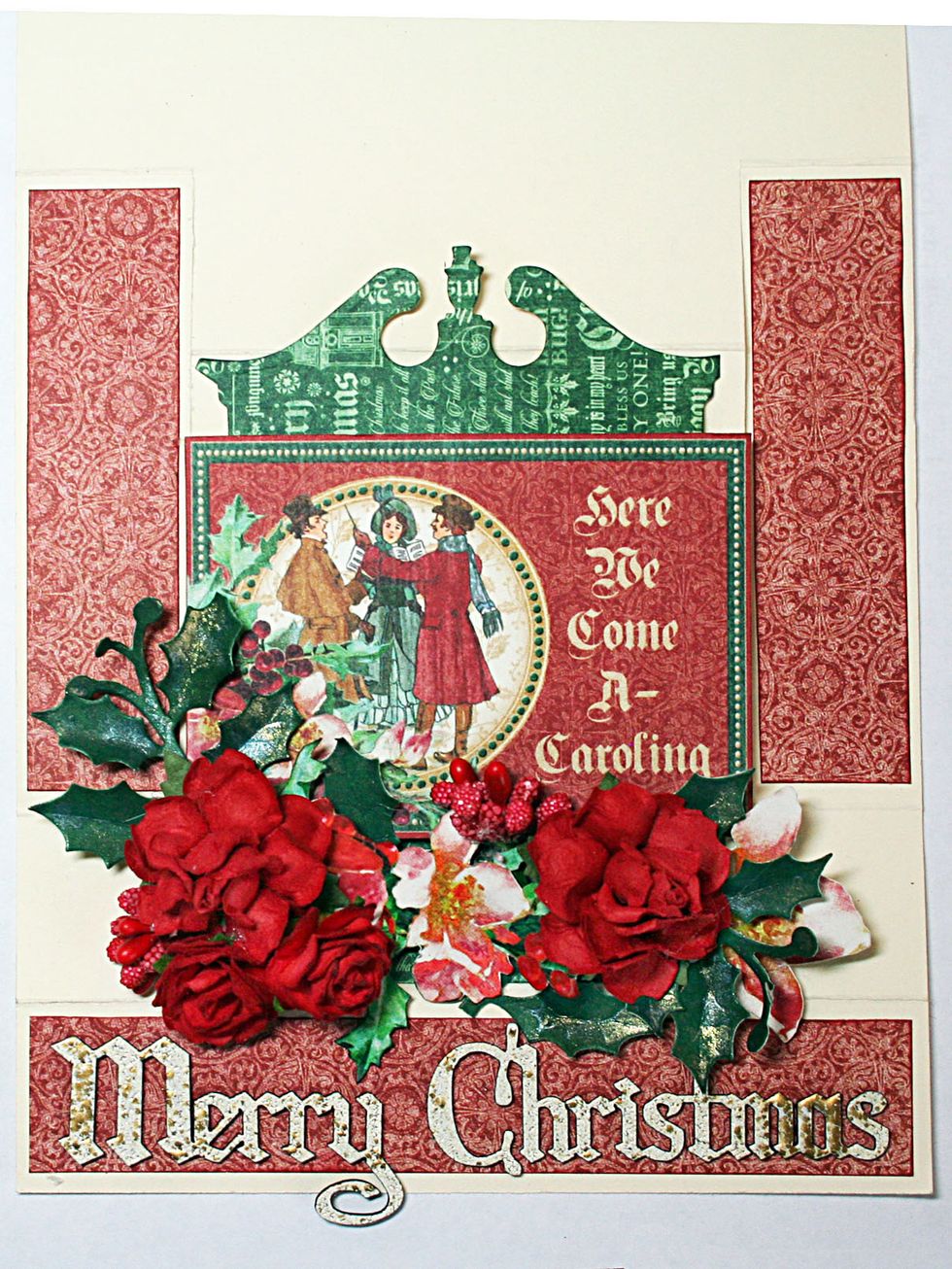 Add a diecut pediment from green patterned paper and attach at the top of the card such that it stands up higher than the height of the card. Adhere flowers & berries over the holly leaves as shown.