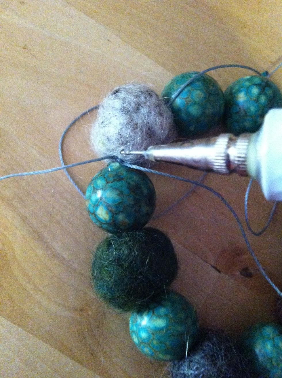 Add a drop of glue or clear nail polish to seal the knots. Let dry.