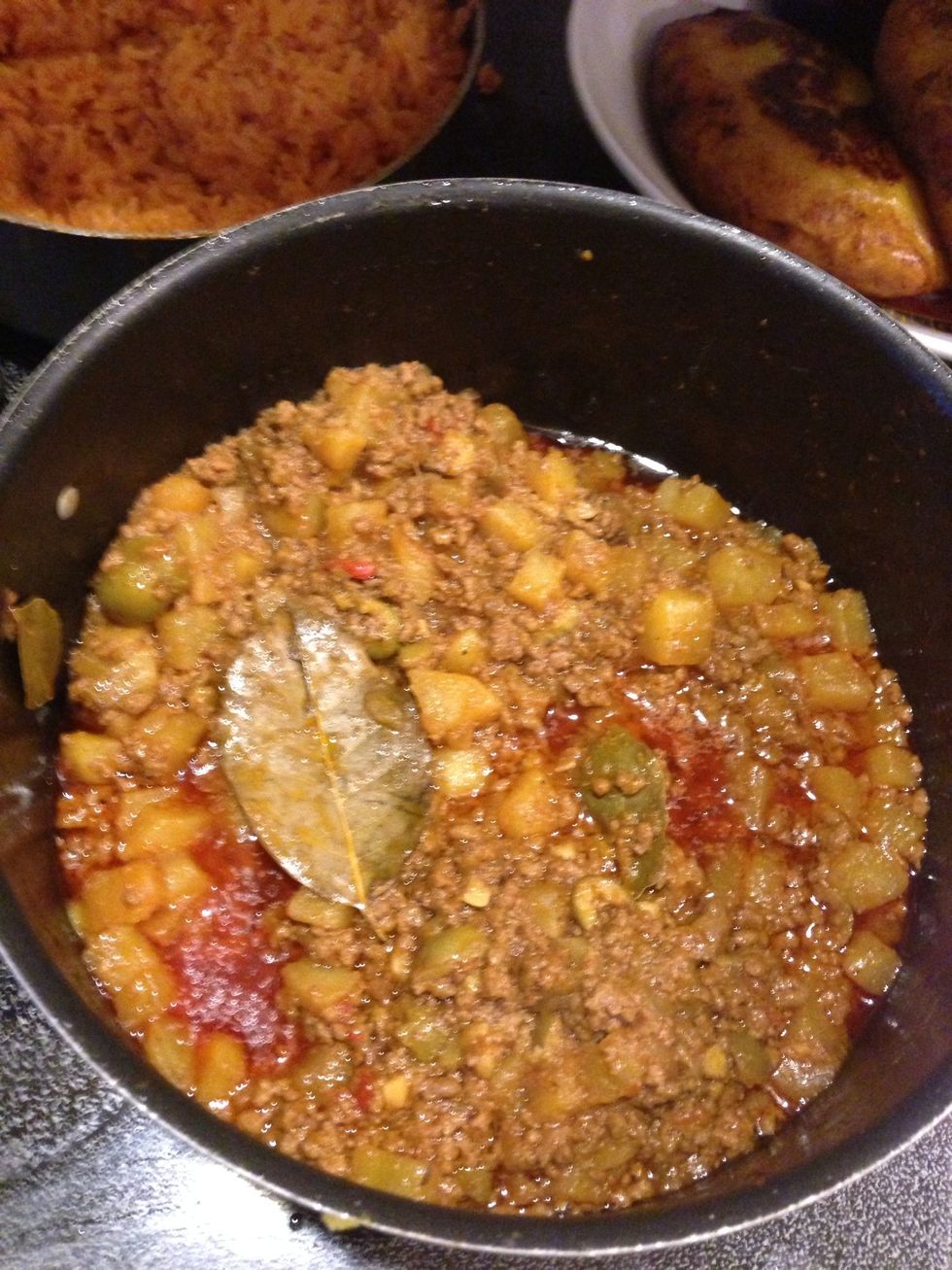 Add a few Bay leaves for flavor, mix well and continue to simmer over low heat...