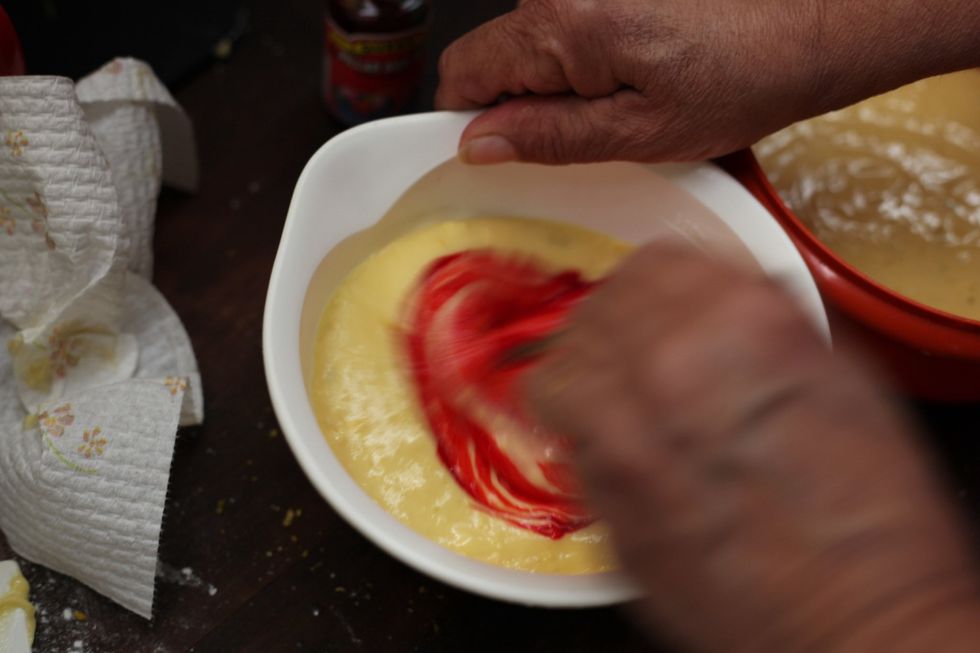 Add a few drops of red food coloring into your first bowl and mix with a spoon. More coloring, more intense colour.