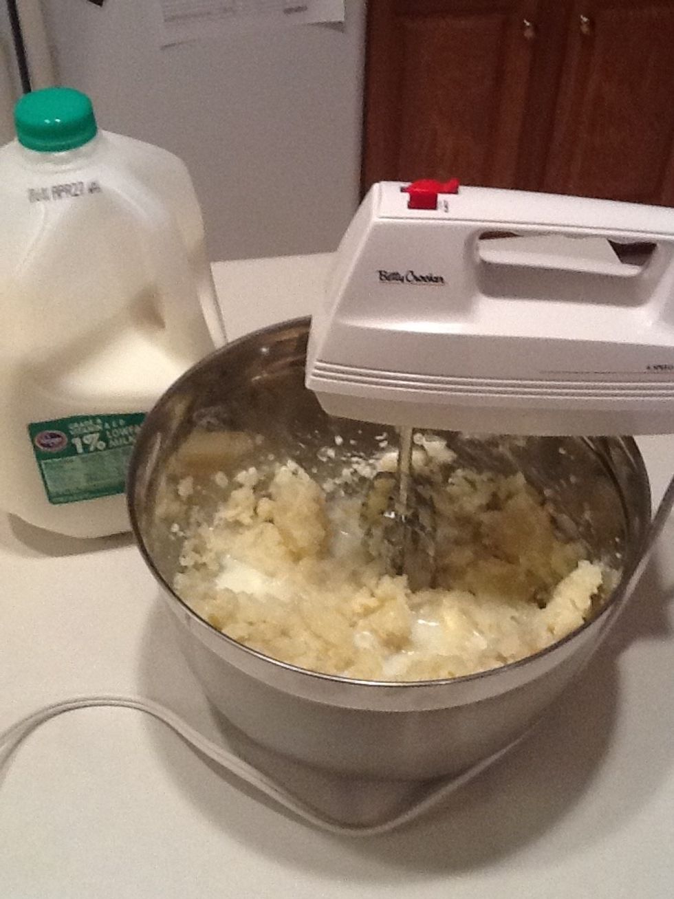 Add a few splashes of milk, then mix. Continue in this manner until the potatoes are the consistency you like (less milk for chunky mashed potatoes; more milk for smoother mashed potatoes.)