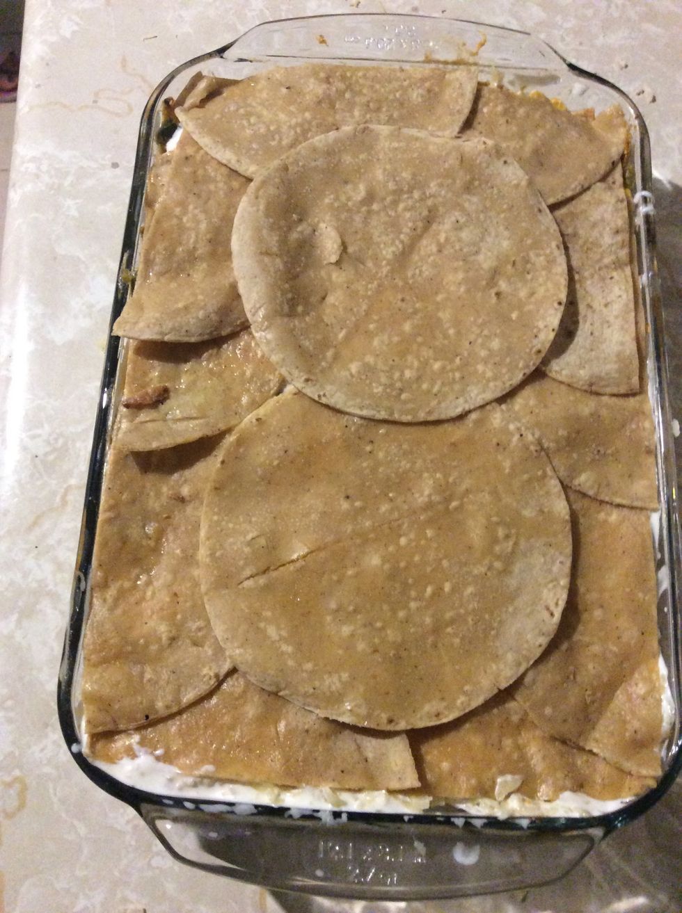 Add a final layer of tortillas and cover with foil