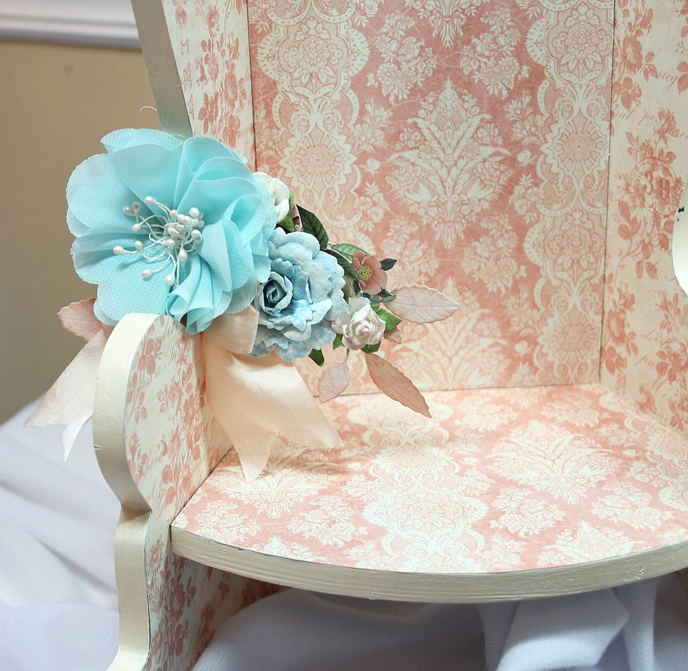 Add a floral cluster to the chair arm.