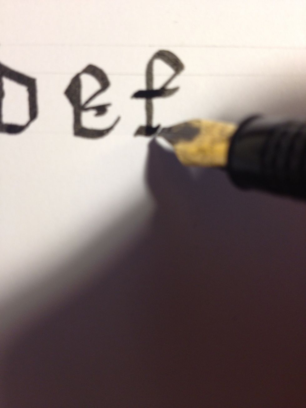 Add a "foot" to the letter by making a sharp upward stroke, shallow downward, and another sharp upward. This gives the base a distinctly "wavy" shape. Practice making the foot; you will use it often.