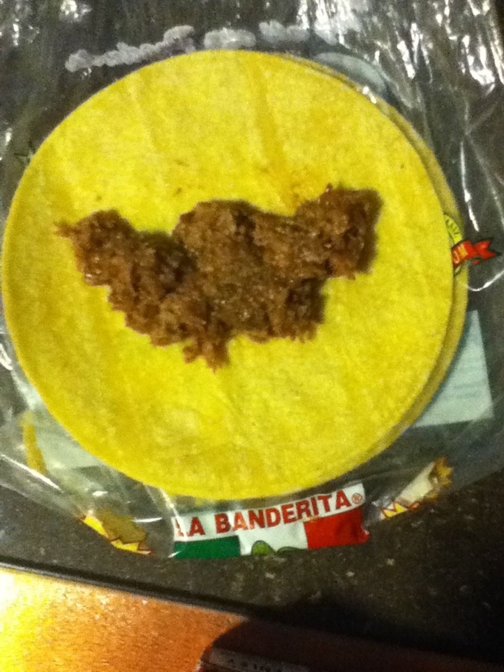 Add a generous amount of the meat mixture to the center of your corn tortilla. There's no particular amount just whatever fancies you :)