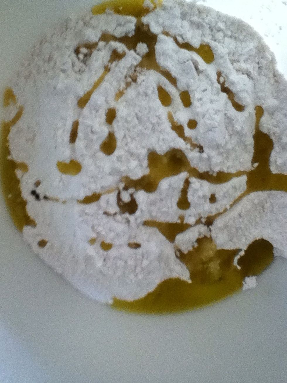 Add a good glug of olive oil, salt, and half of the garlic to the flour