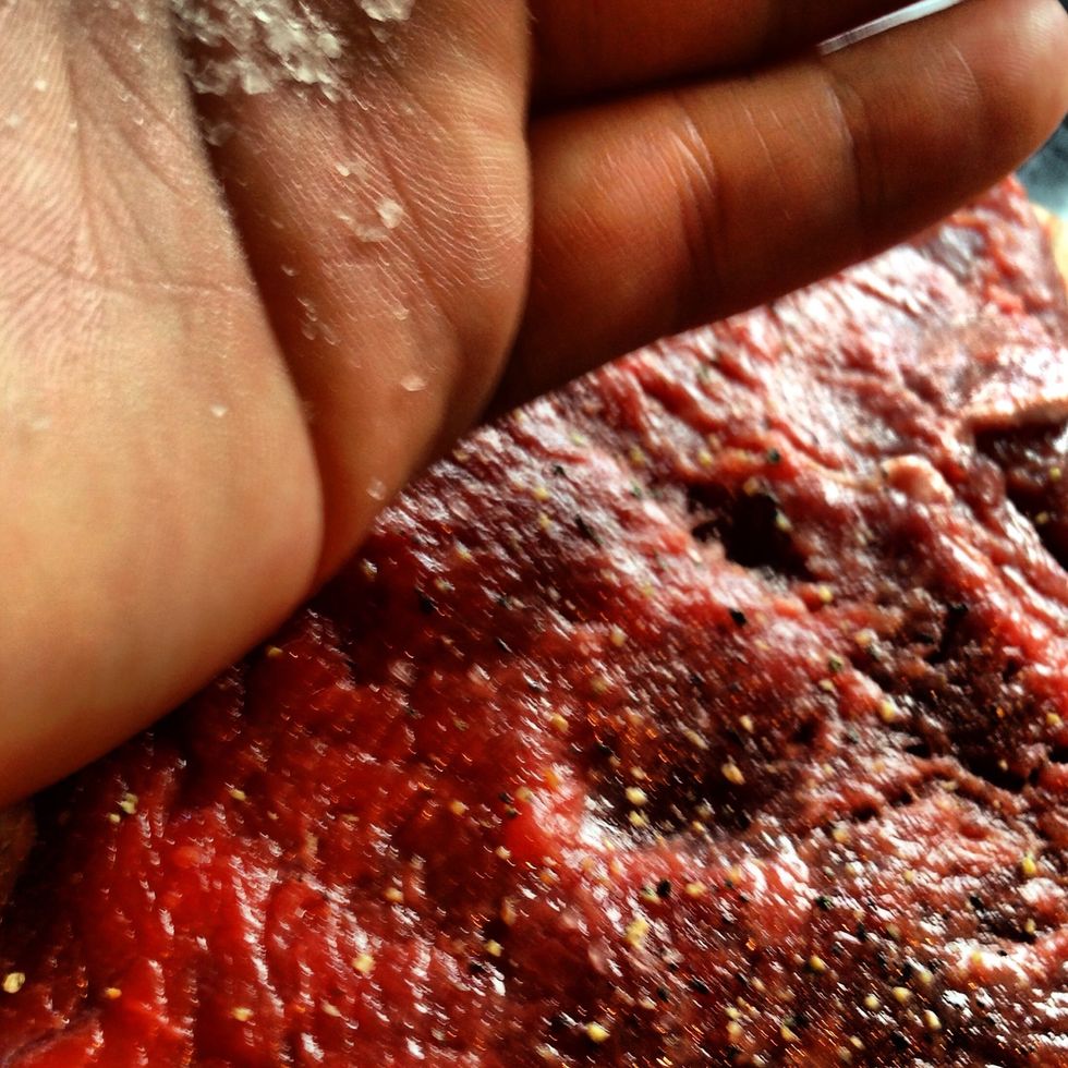 Add a good pinch of salt and pepper to both sides and rub into the meat and oil.