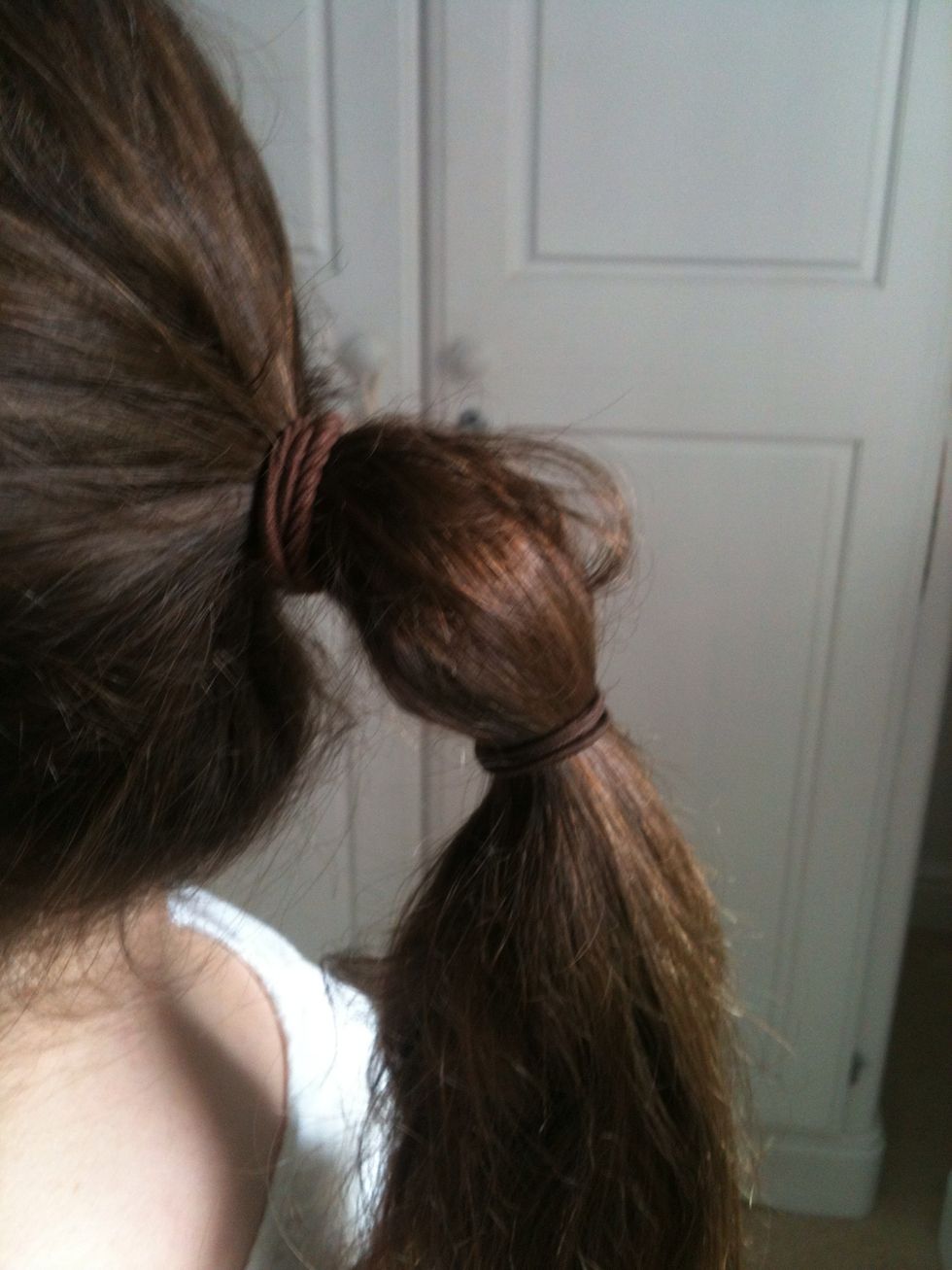 Add a hair tie a few inches below the first.