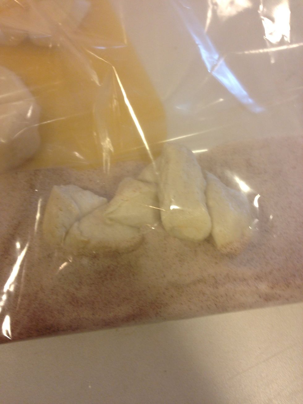 Add a handful at a time to sugar/cinnamon mixture