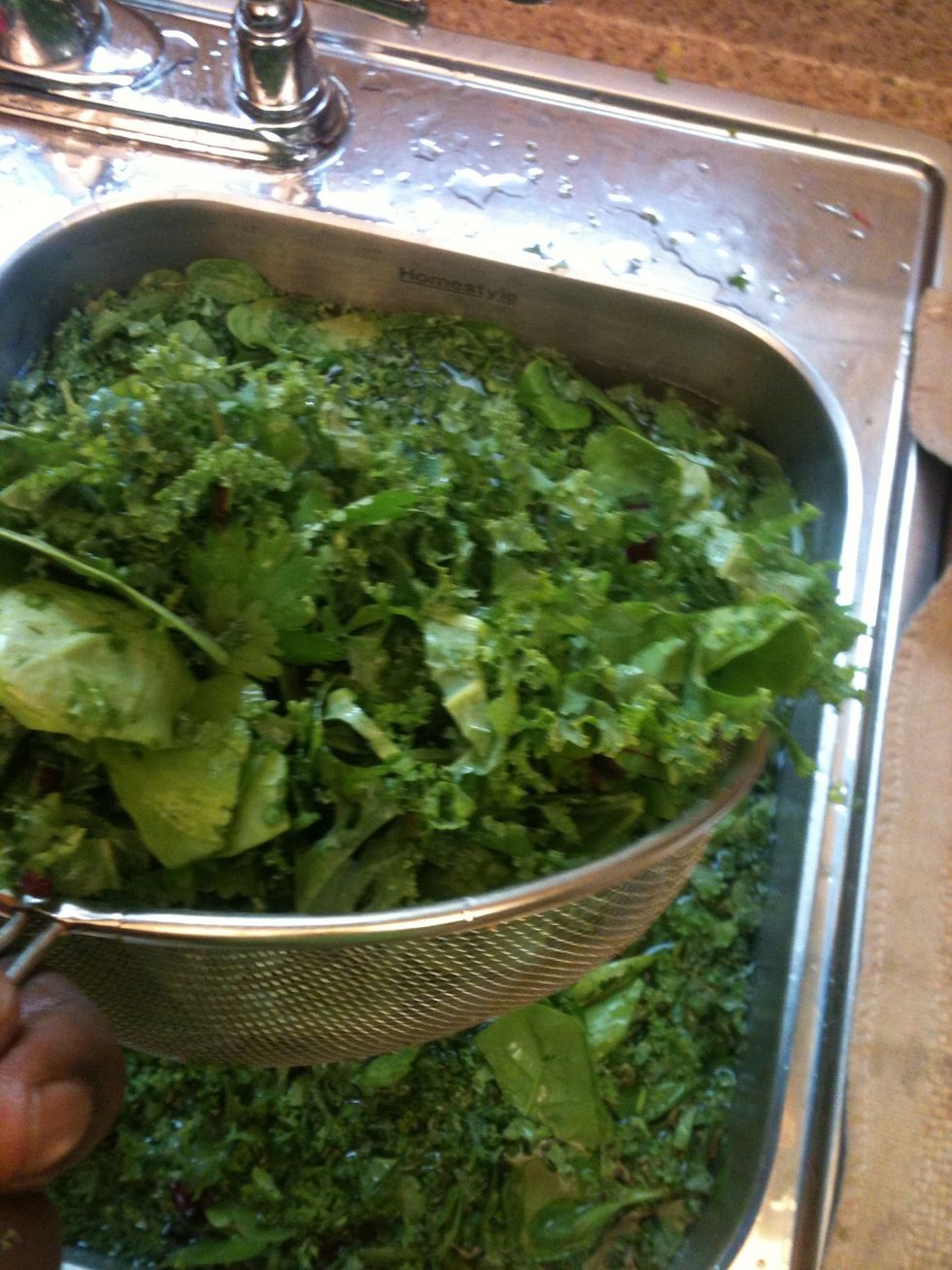 Add a heaping scoop of good greens to the blender. Don't over fill it with greens you still have to add water. I try to leave a half inch of space in the blender, just to be safe!