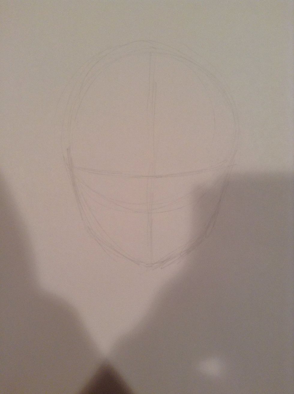 Add a "jaw" to that circle and very lightly draw a line down the center of the face, and another horizontal line just above the edge of the circle. The eyes will go here.