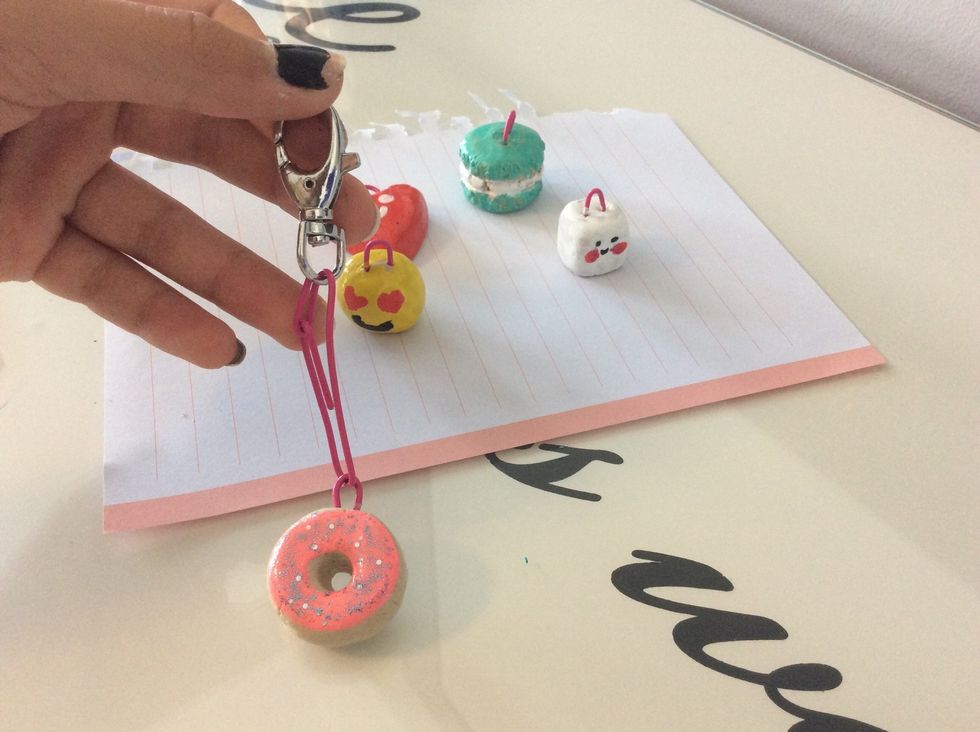 Add a key chain clip at the top of the paper clip and loop the end of the paper clip around another part of it so the key chain clip does not fall off