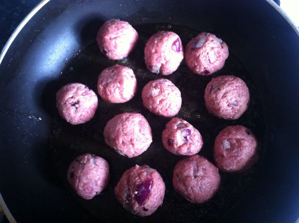 Add a knob of butter to a frying pan, wait until the butter turns golden brown then add your meatballs.