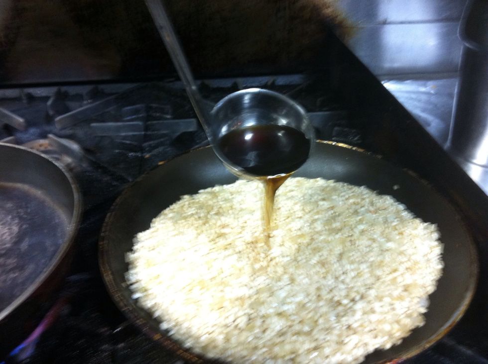 Add a ladleful of stock to the rice. Stir until it is absorbed. Continue adding sock and stirring until the rice is cooked