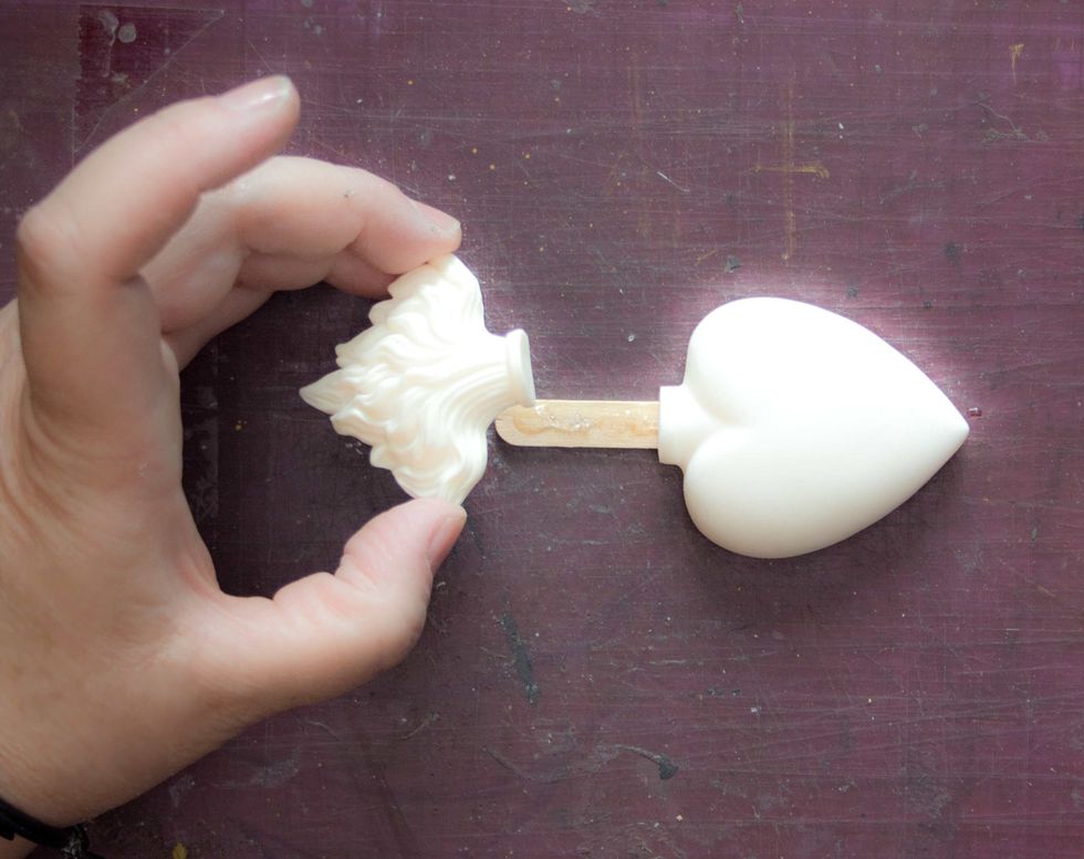 Add a layer of heavy-duty adhesive to the stick, and place the Heart and Flame on top. Allow to cure.
