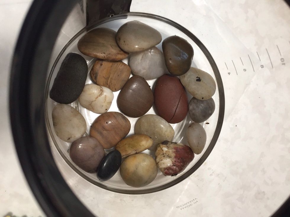 Add a layer of rocks or pebbles to bottom of coffee pot.