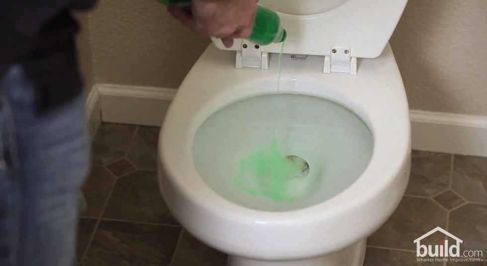 Add a liberal amount of dish soap to the toilet. Since the dish soap is heavier than the water, it will sink straight to the bottom.