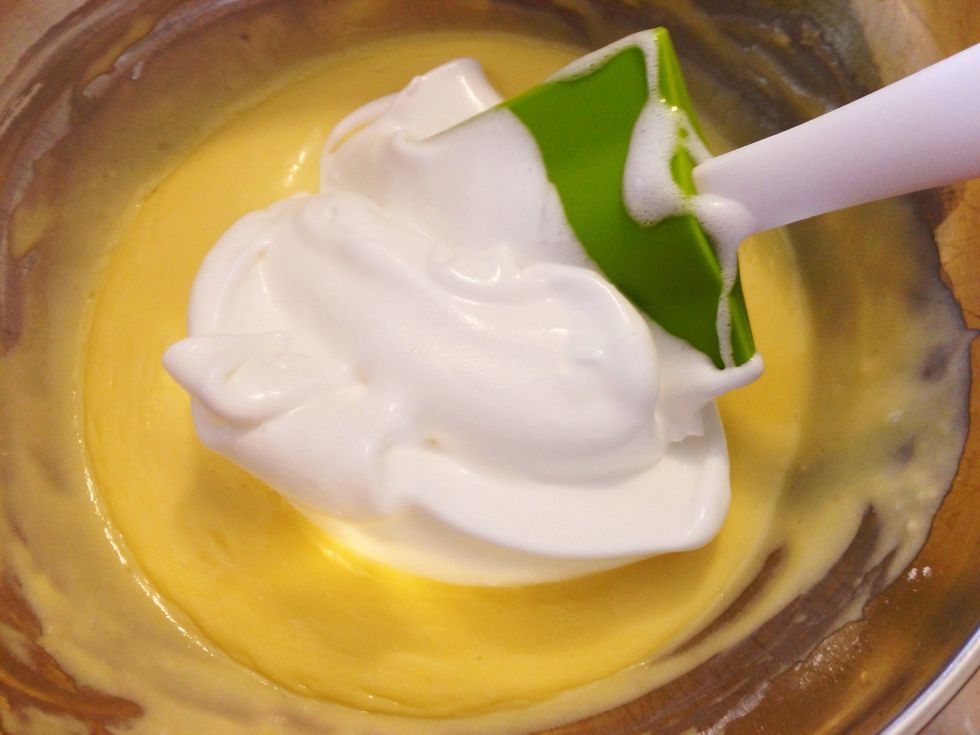 Add a little bit of the meringue to the egg yolk mixture.