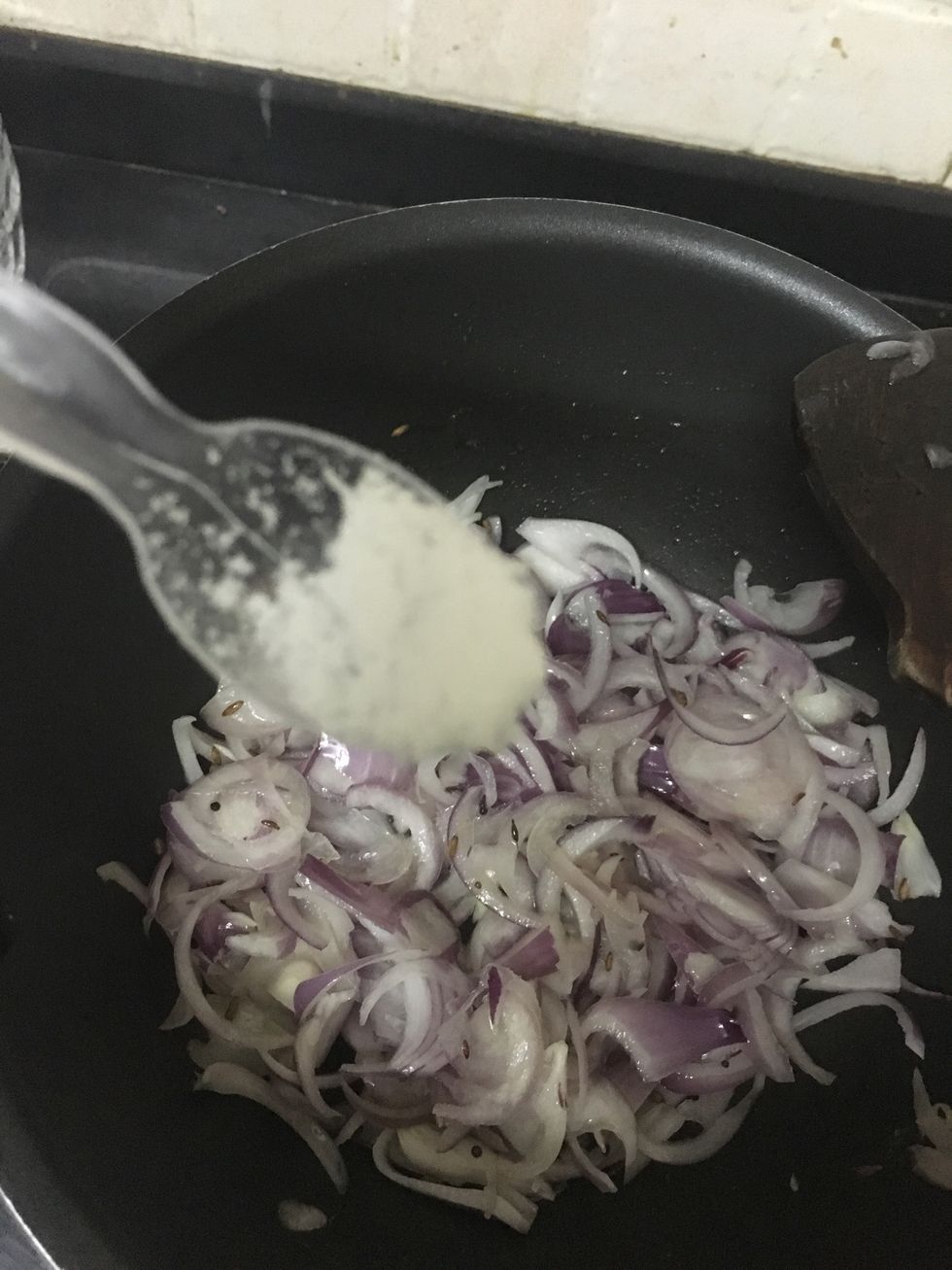 Add a little salt so that the onions will turn brown easily