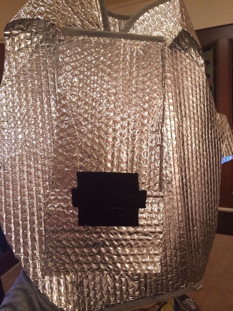 Add a long strip of extra sun shade along the chest area to add for extra support. Then glue gun the Velcro along the end of the strip