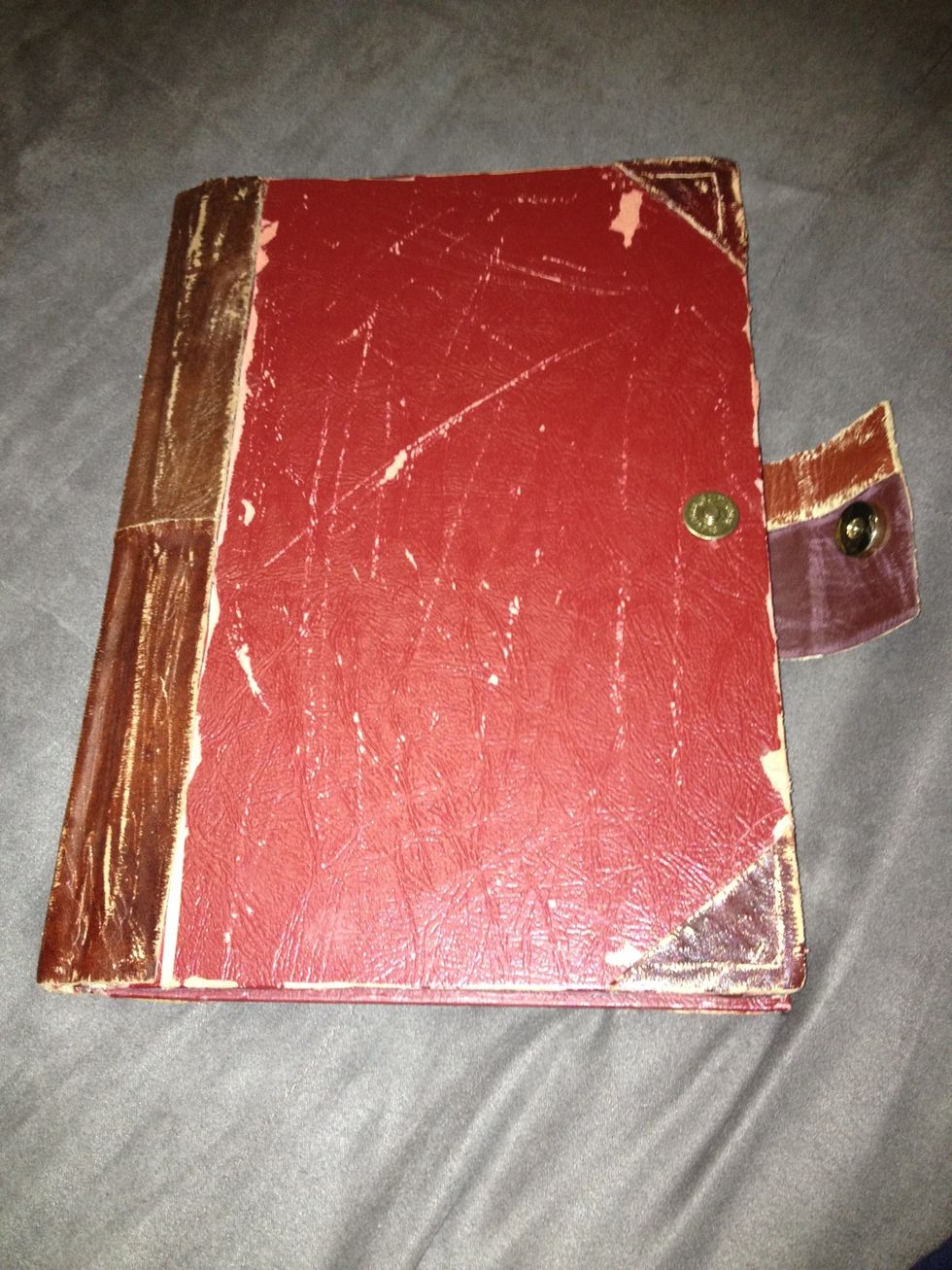 Add a magnetic clasp to the strap and to the top of the case. This can be found at any art store. I actually recycled it from an old bag of mine.