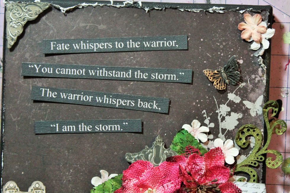 Add a metal butterfly above the flower cluster.