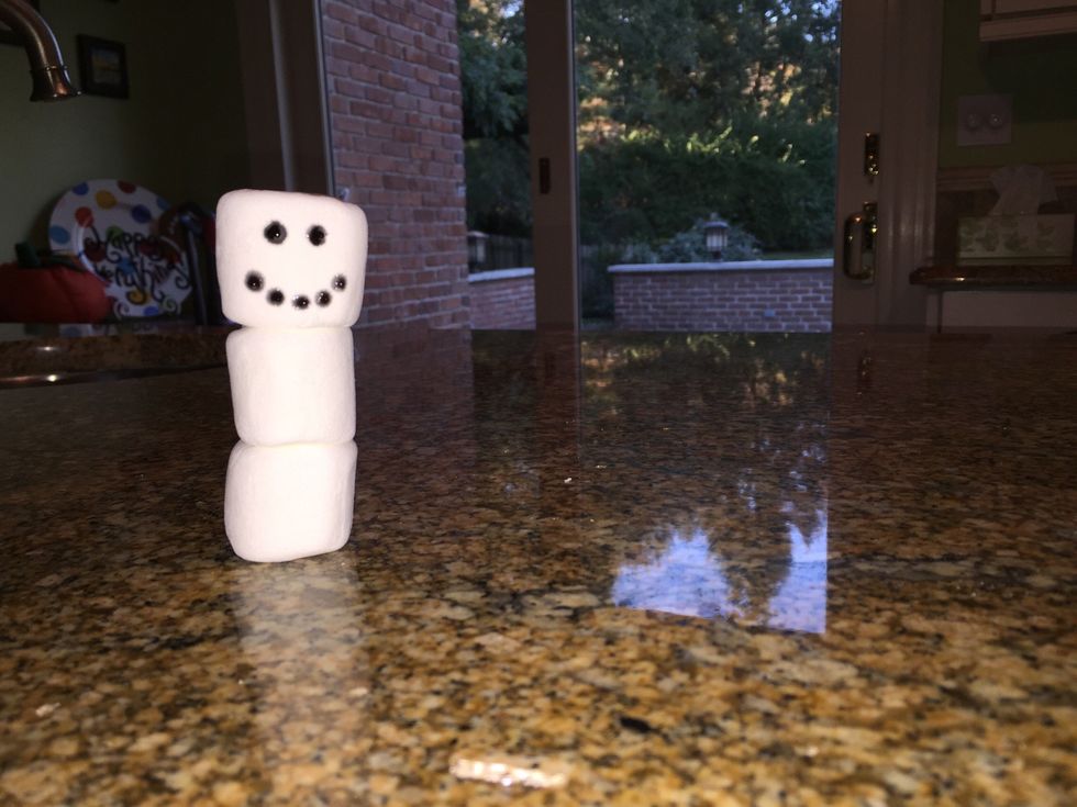 Add a mouth at the bottom of marshmallow #1 by either drawing a solid curved line (beginner) or a dotted curved line (intermediate/advanced).