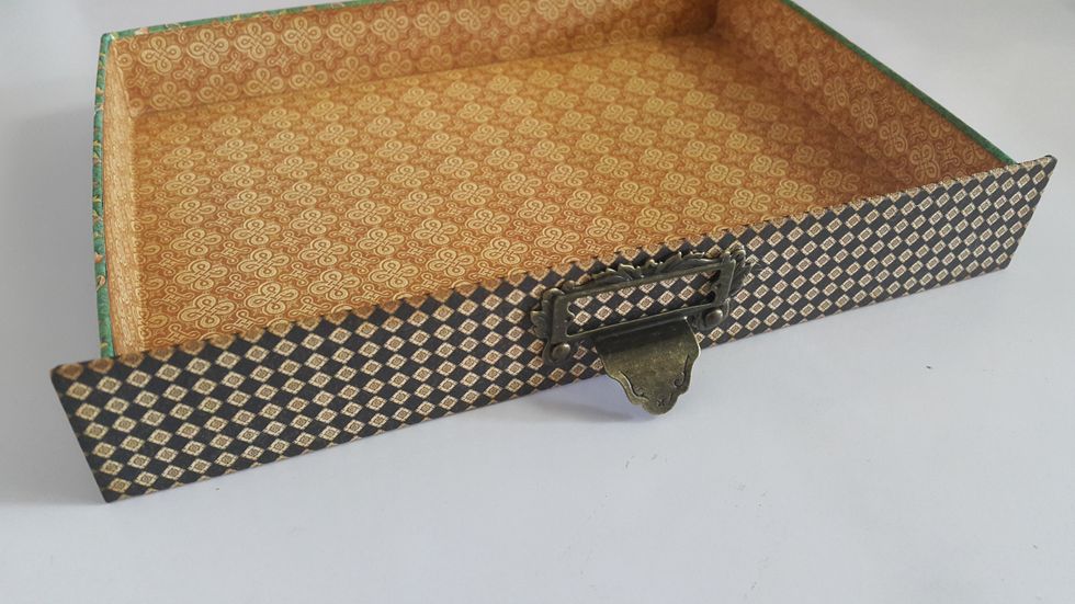 Add a piece of chipboard 8-5/8"x1-1/4" covered with paper (8-5/8"x2-1/4"), fix the handle on and adhere on the front of the drawer