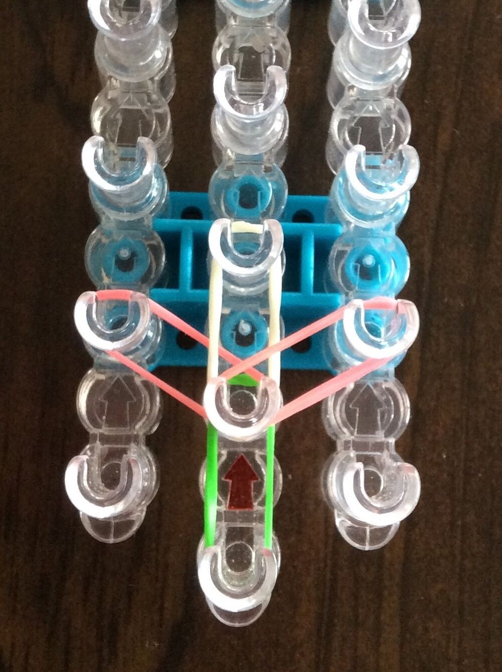 Add a pink band from the second middle peg to the second right peg.