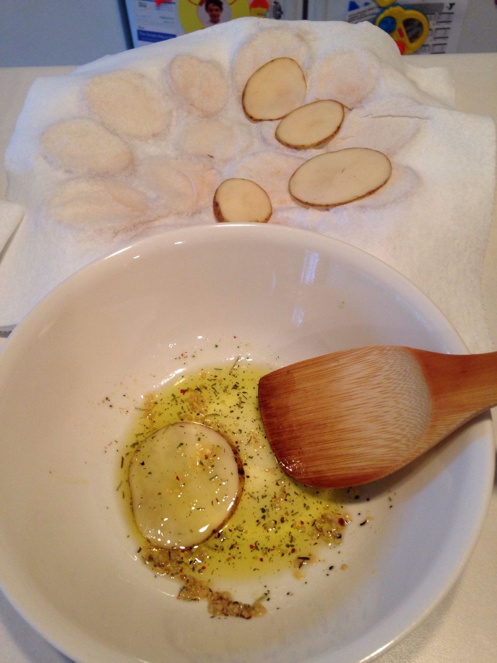 Add a potato slice and coat on both sides. Place potato on foil-lined pan.