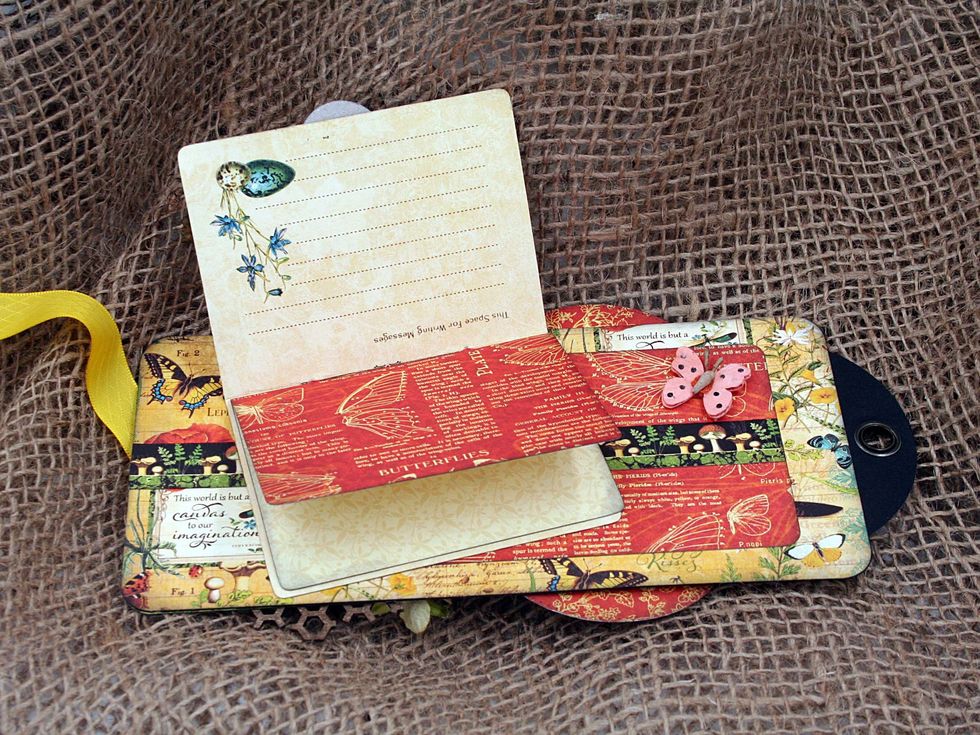 Add a rectangle 3" x 5" and a decorative strip to the back of the cover tag.  Then adhere the little book we made in the previous step at an angle.