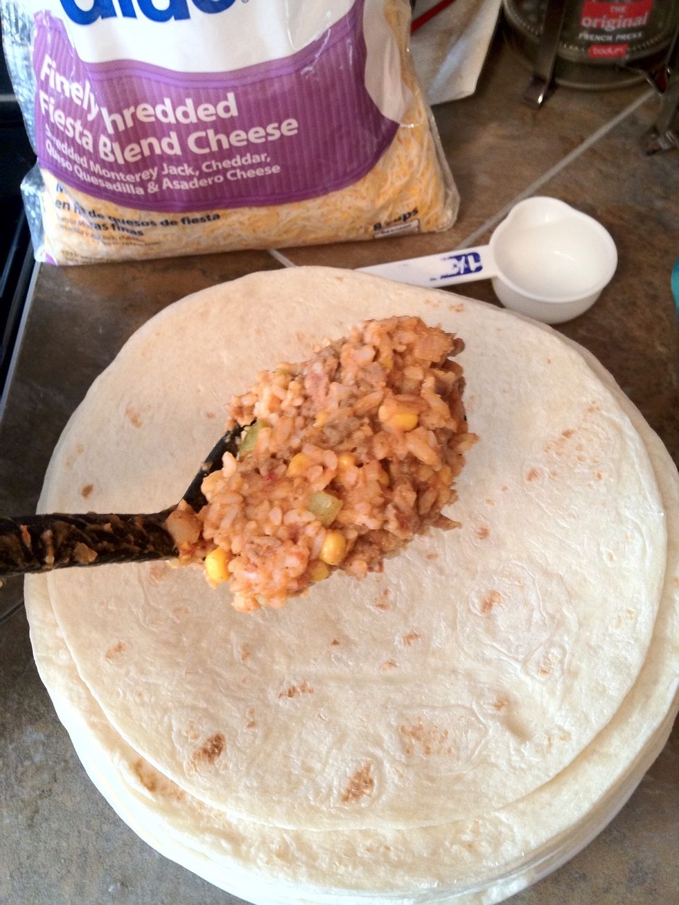 Add a scoop of mix. (not an exact measurement, I know. First time you do this you will either run out of mix or have extra. If you run out, make cheese burritos, if you have extra, burrito bowl!)