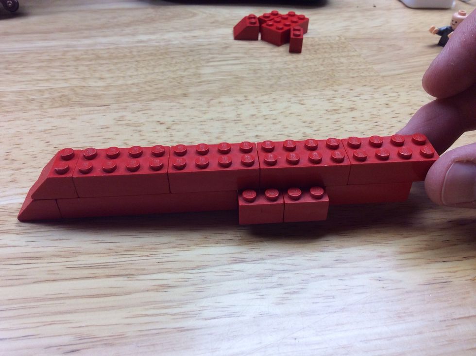 Add a second row of bricks to the base.