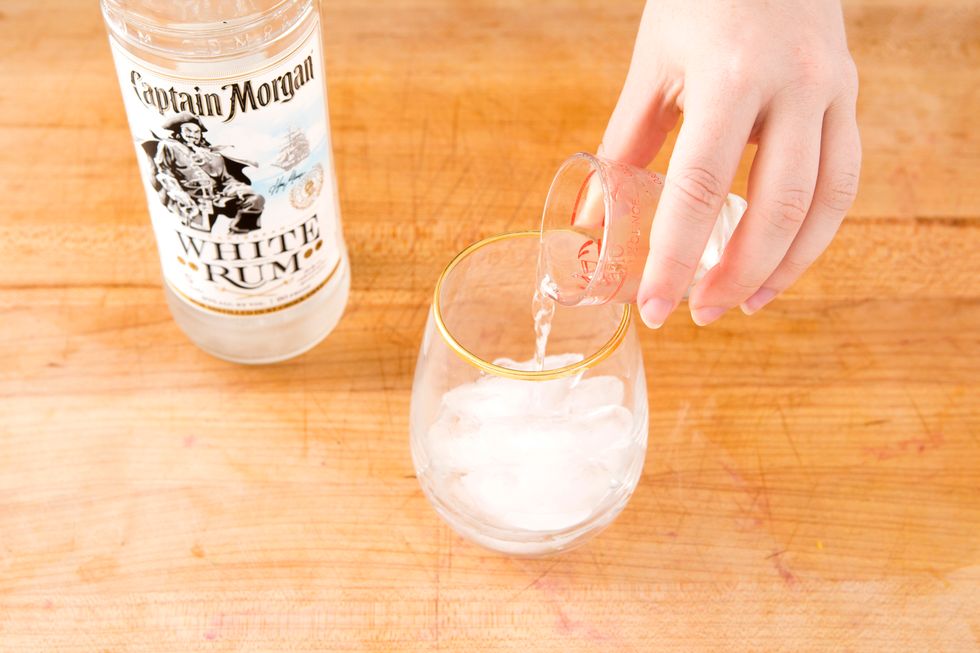 Add a shot or so of white rum to a glass of ice.