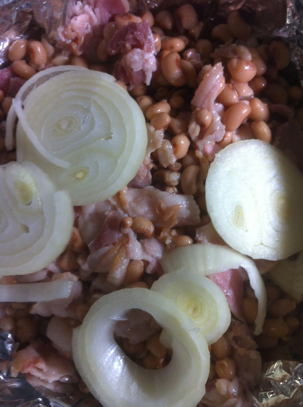 Add a sliced onion and some bacon cut into pieces.