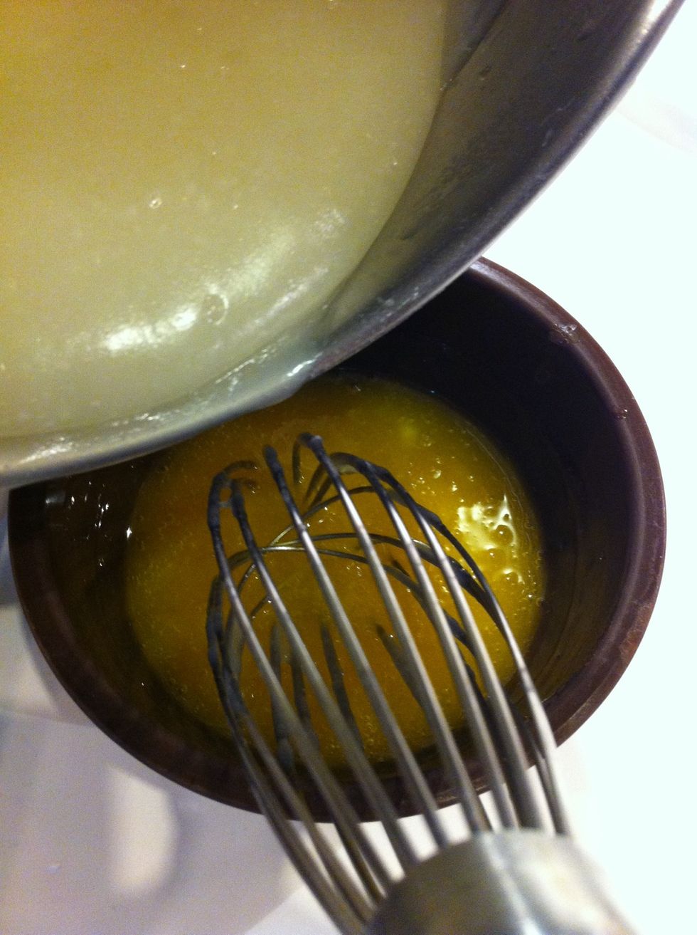 Add a small amount of hot mixture to whisked egg yolks. Tempering! I leave eggs at room temperature a few hours before preparing this so less chance of scrambled yolks!