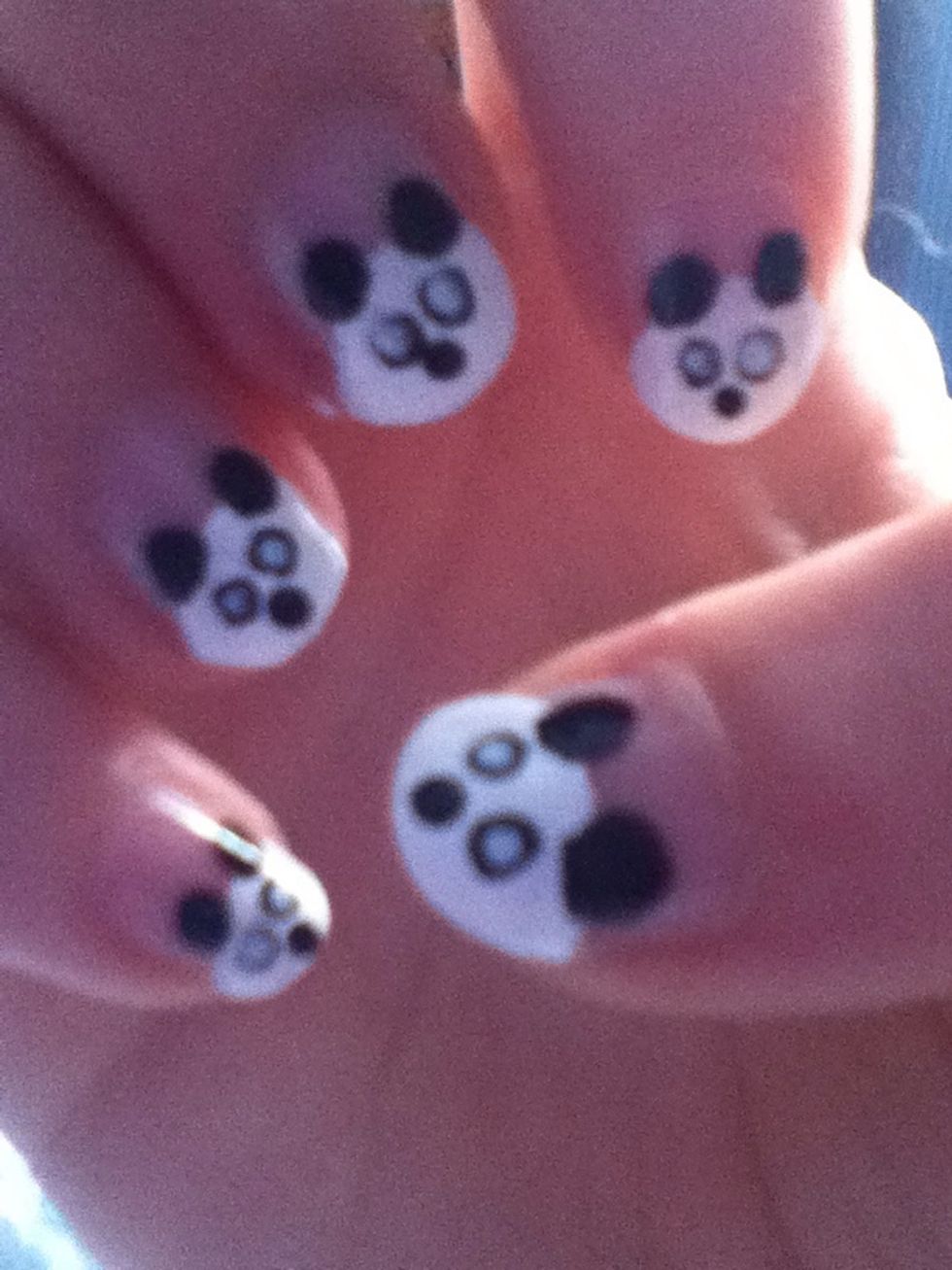 Add a small black dot for the nose. Do this before the next step to let the whites of the eyes dry completely.